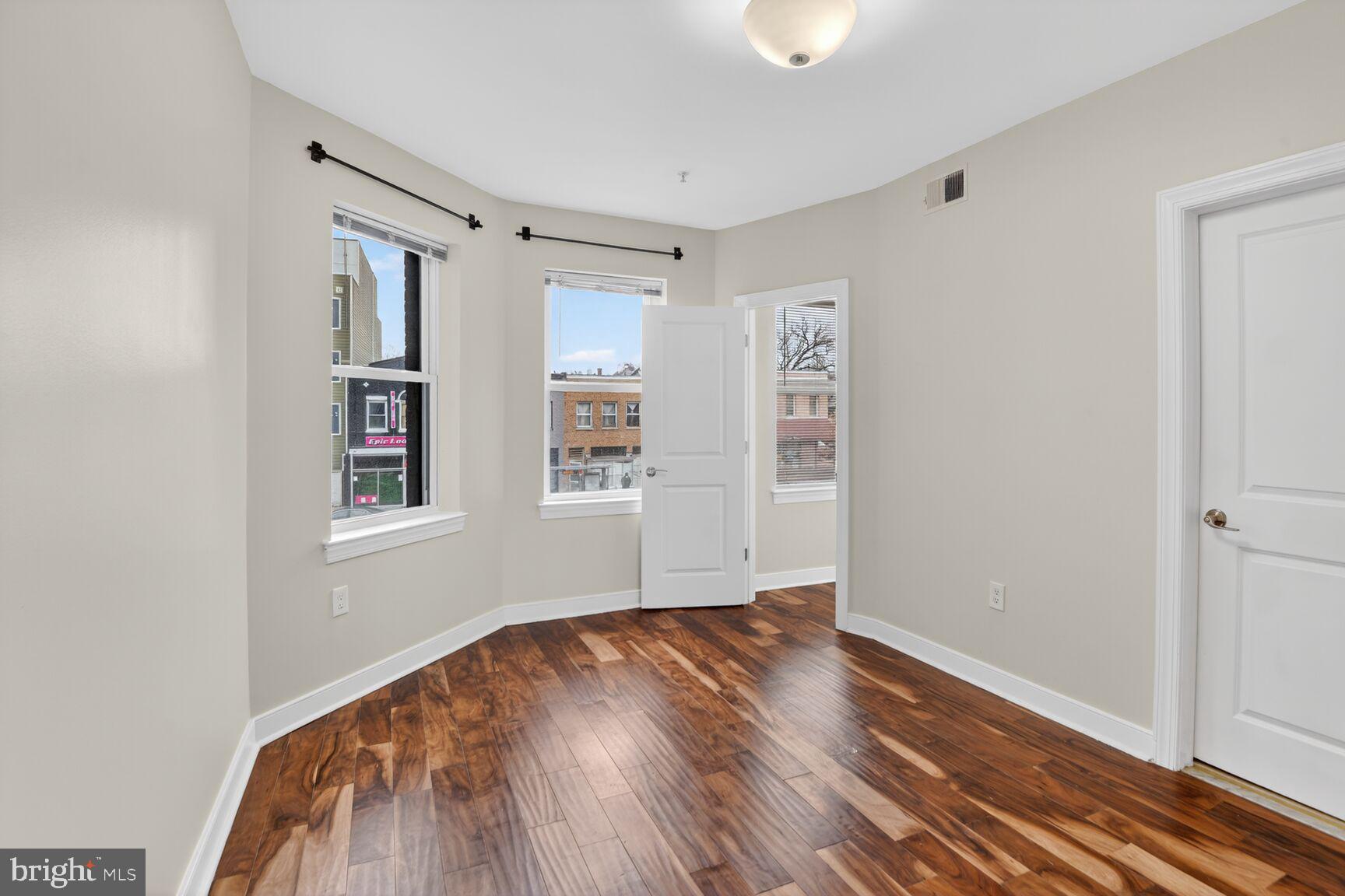 4800 Georgia Avenue Northwest, Unit 205 Washington, DC 20011 - Photo 12 of 15 a view of empty room with wooden floor and fan
