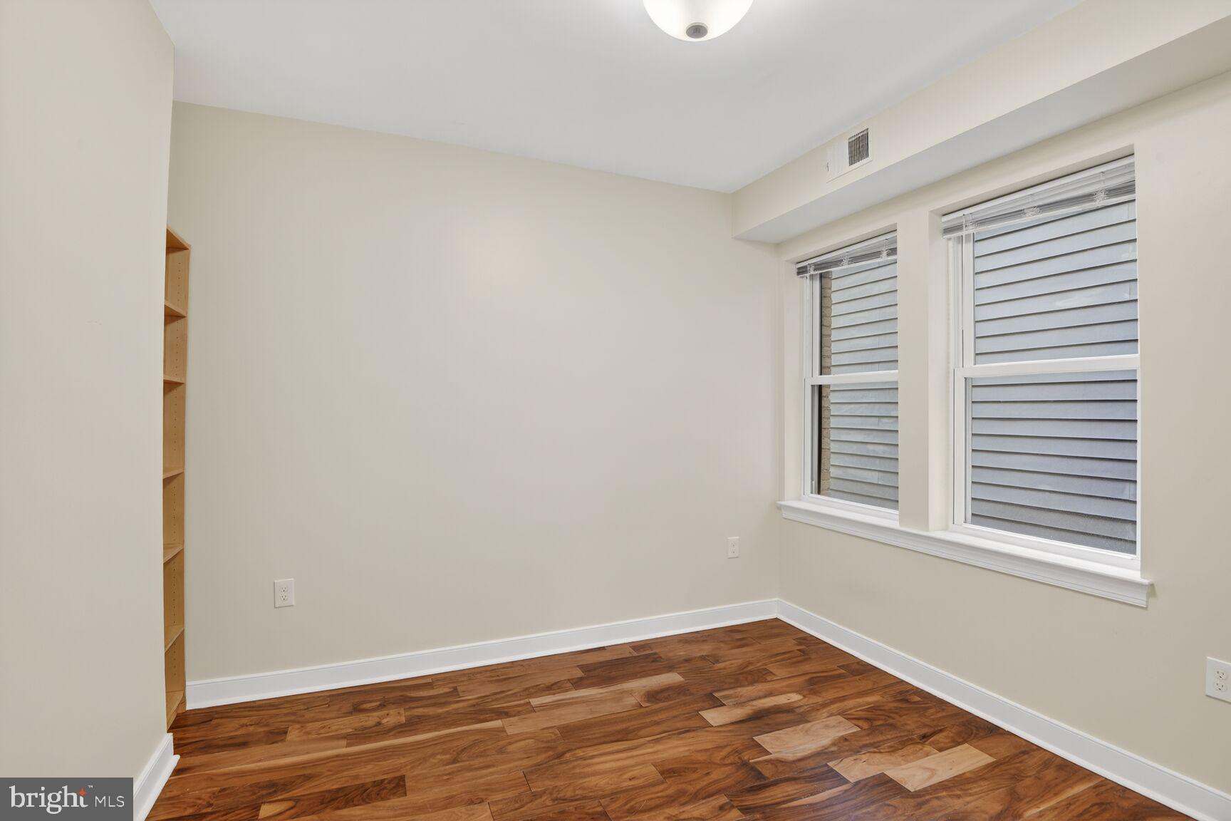 4800 Georgia Avenue Northwest, Unit 205 Washington, DC 20011 - Photo 8 of 15 a view of an empty room with wooden floor and a window