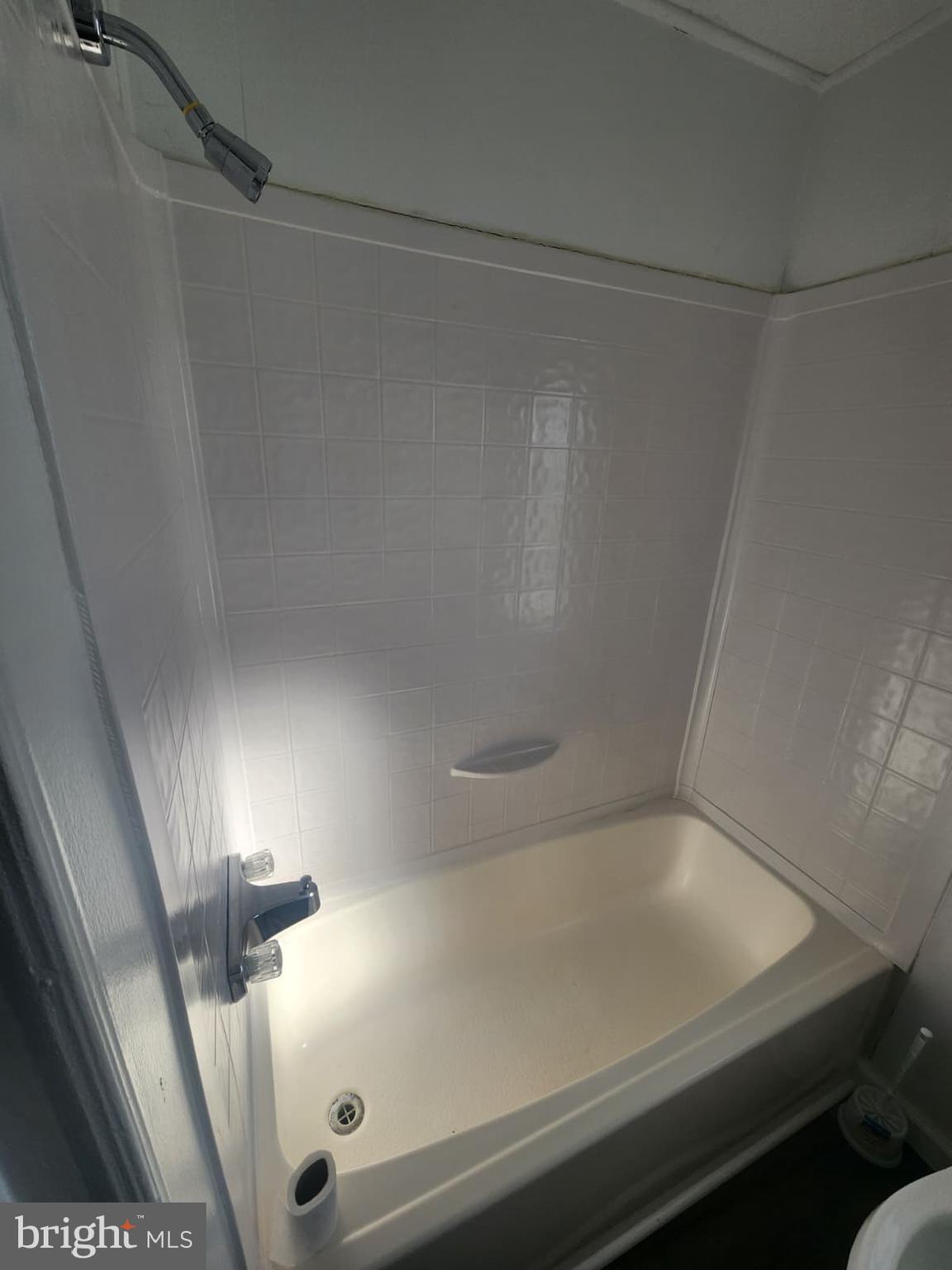 4191 Lake Road, Unit 28 Newfield, NJ 08344 - Photo 11 of 12 a bathroom with a shower and tub