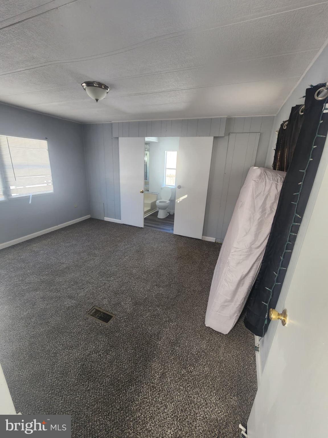 4191 Lake Road, Unit 28 Newfield, NJ 08344 - Photo 3 of 12 an empty room with windows