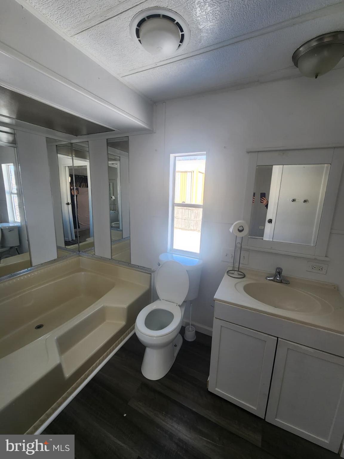 4191 Lake Road, Unit 28 Newfield, NJ 08344 - Photo 5 of 12 a bath room with a sink and a mirror