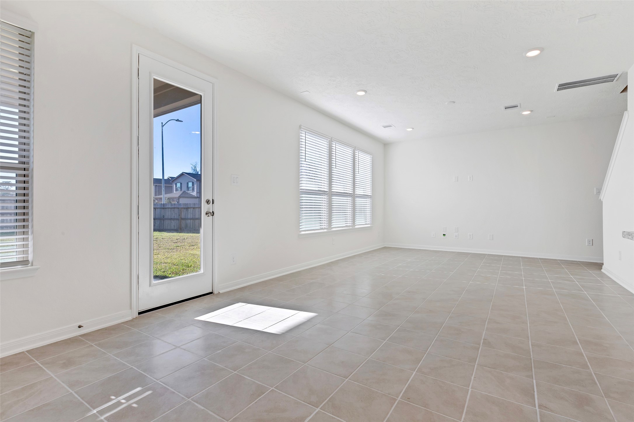 9423 Castillo Court Magnolia, TX 77354 - Photo 11 of 28 The spacious living room is filled with natural light, featuring multiple windows that create an open and airy feel.