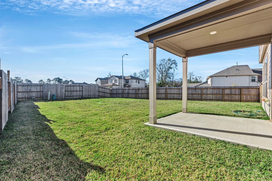 9423 Castillo Court Magnolia, TX 77354 - Photo 26 of 28 this home also offers a fully fenced backyard with a covered patio—perfect for relaxing evenings or hosting get-togethers.
