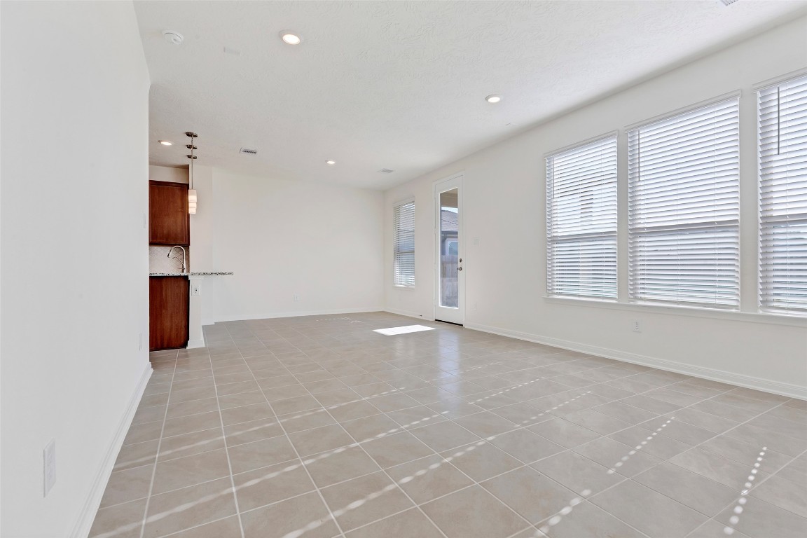 9423 Castillo Court Magnolia, TX 77354 - Photo 8 of 28 The spacious living room is filled with natural light, featuring multiple windows that create an open and airy feel.