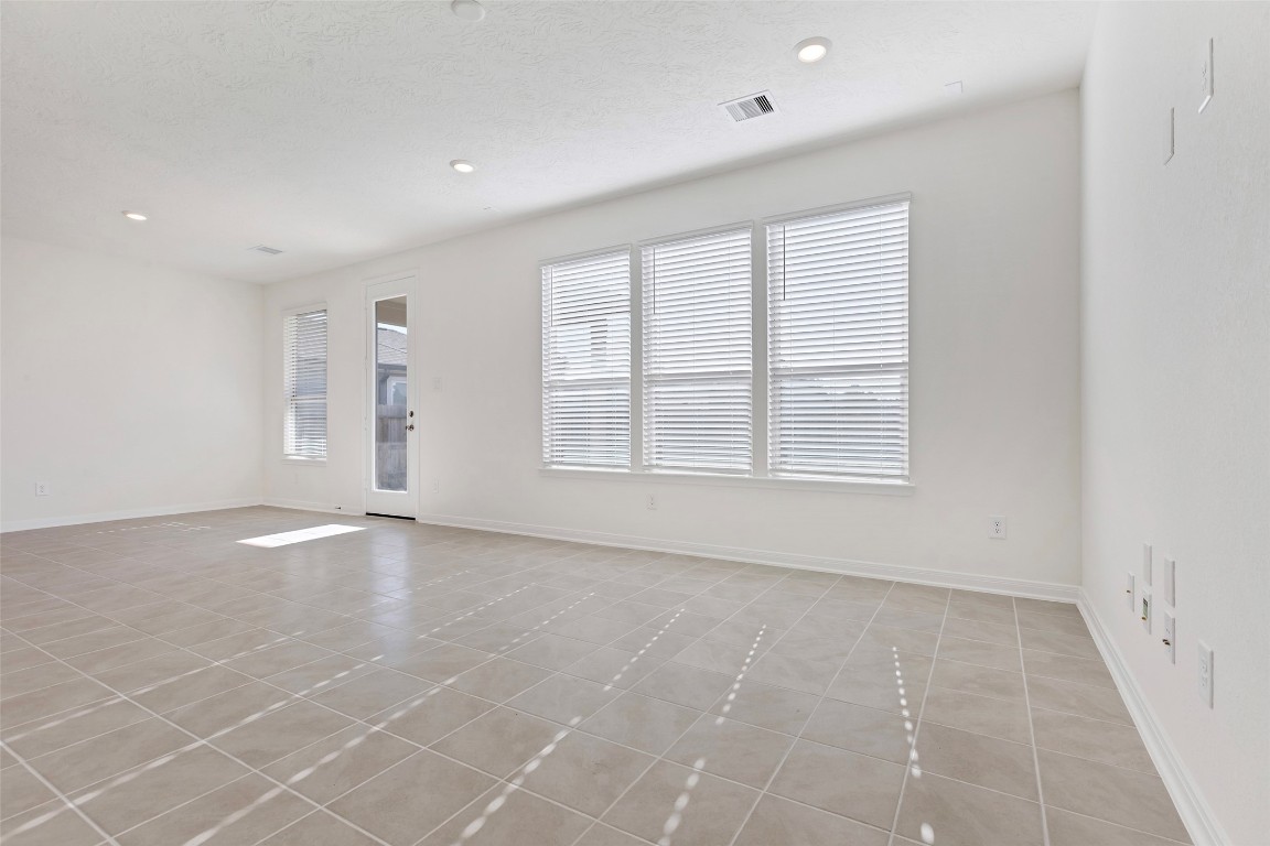 9423 Castillo Court Magnolia, TX 77354 - Photo 9 of 28 The spacious living room is filled with natural light, featuring multiple windows that create an open and airy feel.