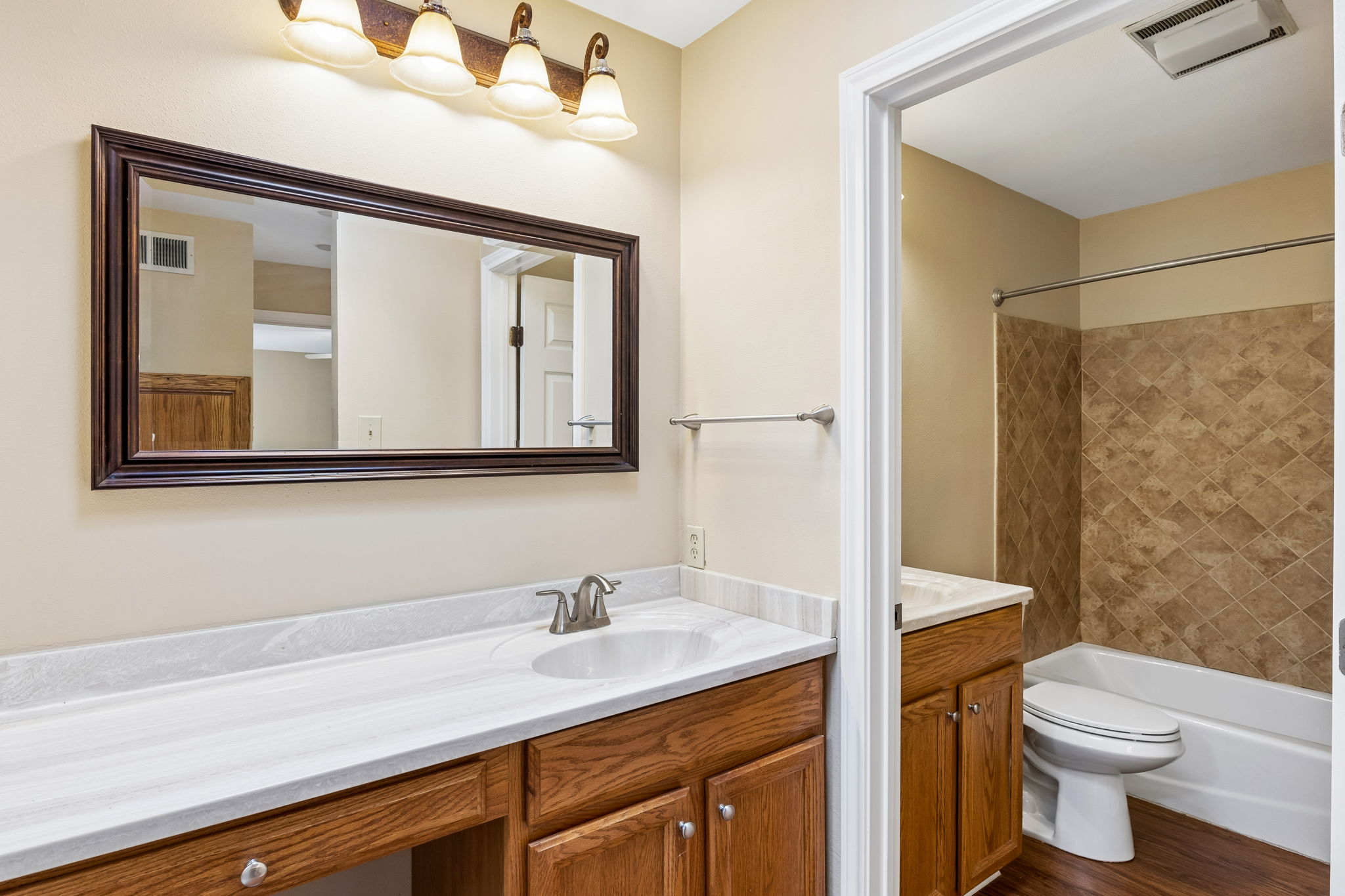 8340 Fathom Circle, Unit 103 Austin, TX 78750 - Photo 21 of 30 a bathroom with a toilet a sink and mirror