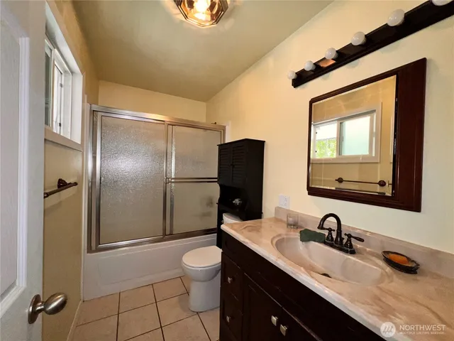 a bathroom with a sink a toilet and a mirror