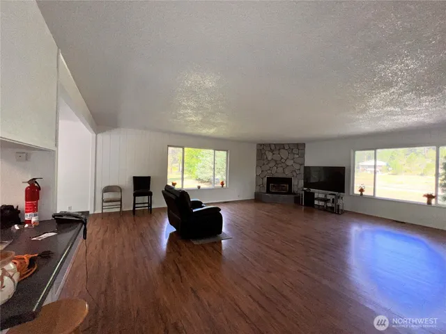a living room with fireplace furniture and a wooden floor