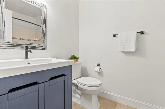 a bathroom with a sink a toilet and mirror