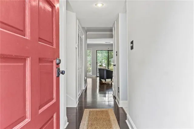 a hallway with a dining table and a livingroom view