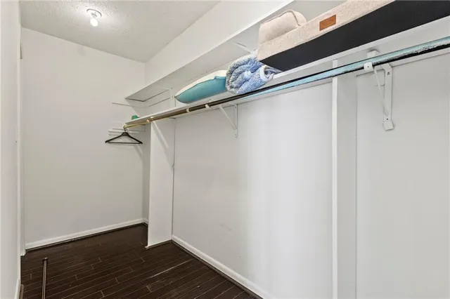 a view of a room with wooden floor