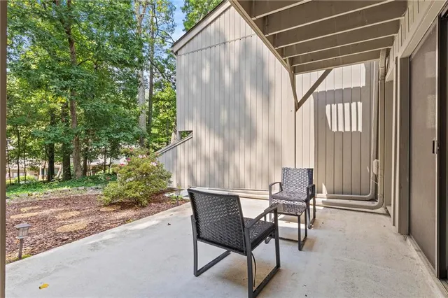 a backyard of a house with table and chairs