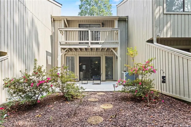 a potted plant sitting in front of a house with a yard