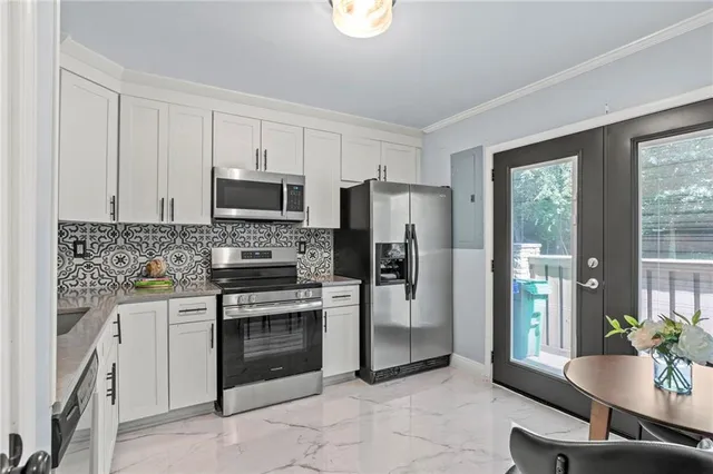 a kitchen with a stove a sink and a refrigerator