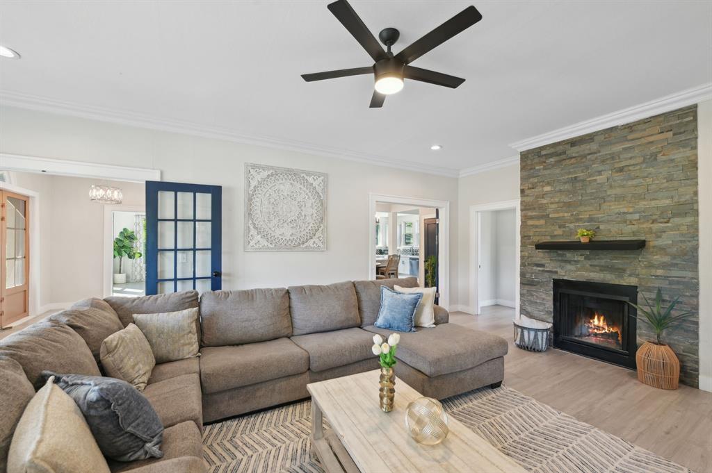 702 Griffith Avenue Terrell, TX 75160 - Photo 15 of 40 a living room with furniture a fireplace and a ceiling fan