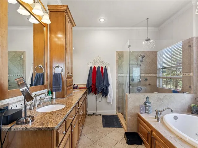 a bathroom with a tub sink and mirror