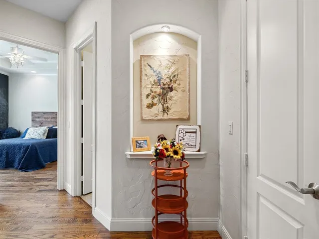 a room with painting and a potted plant