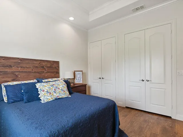 a bedroom with a bed and a night stand