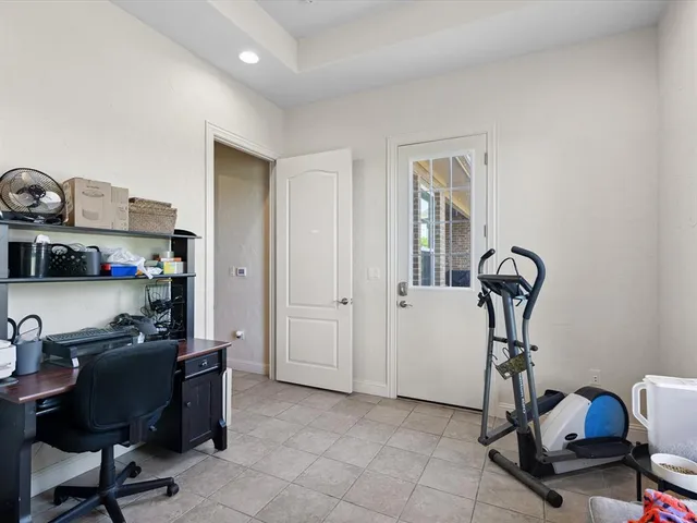 a view of a workspace with furniture and a window