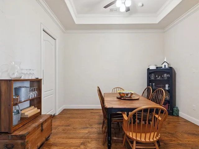a view of a dining room with furniture and wooden floor