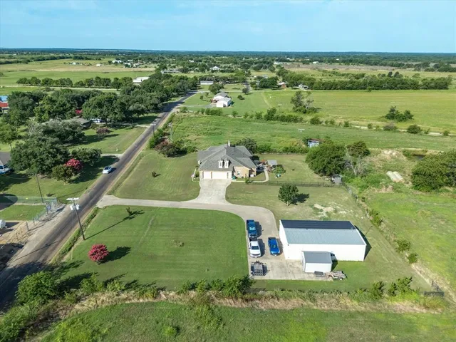 an aerial view of a house with a yard