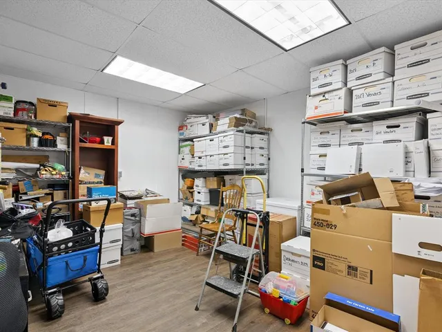 a living room with lots of furniture and clutter