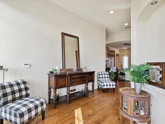 a living room with furniture and flowers