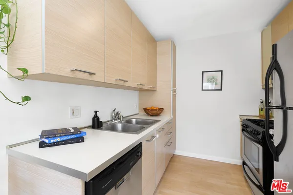 a kitchen with stainless steel appliances a sink and a refrigerator