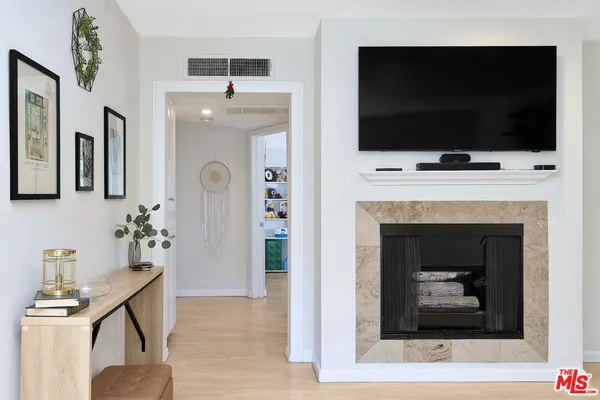 a living room with a fireplace and a flat screen tv