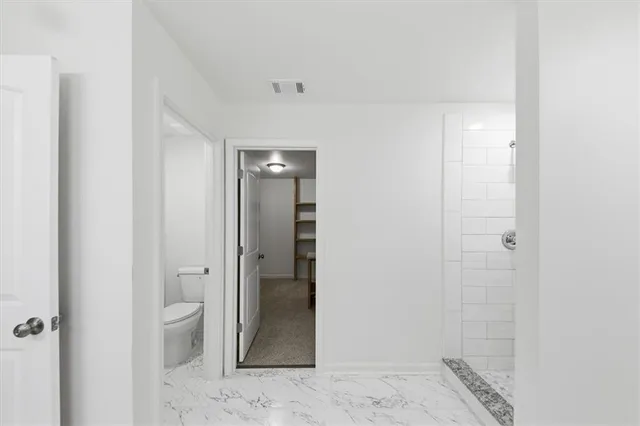 a bathroom with a granite countertop sink