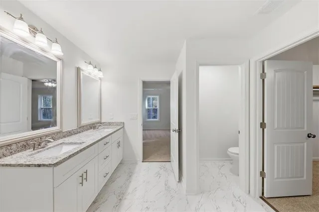 a bathroom with a granite countertop sink mirror and a