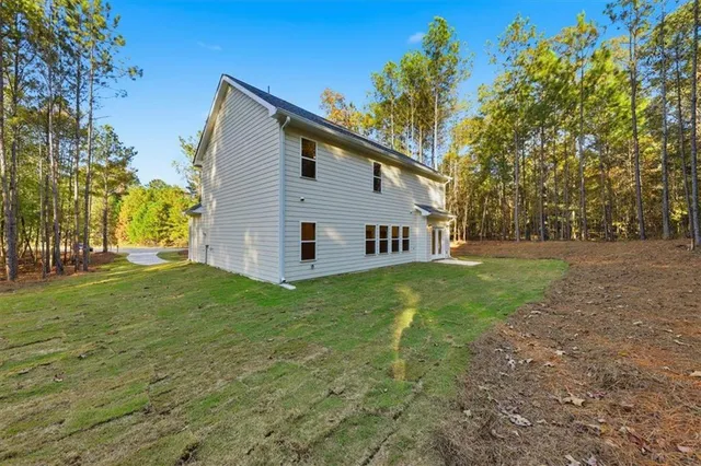 a view of a backyard with large trees