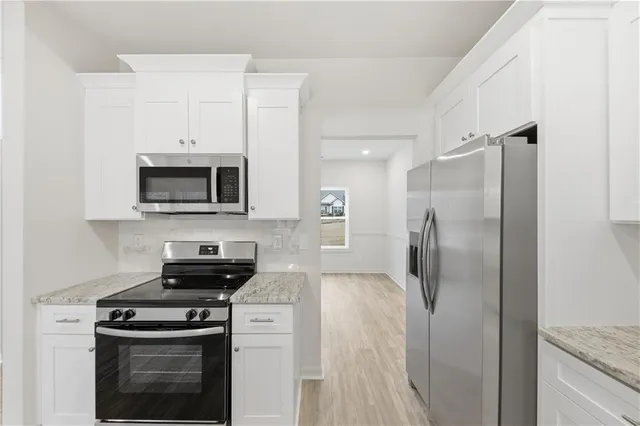 a kitchen with a stove and a refrigerator