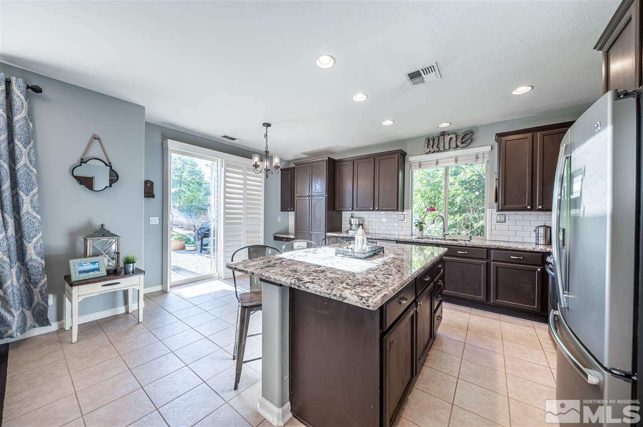 2580 Country Falls Lane Reno, NV 89521 - Photo 8 of 35 a kitchen with stainless steel appliances granite countertop a stove a sink and a refrigerator