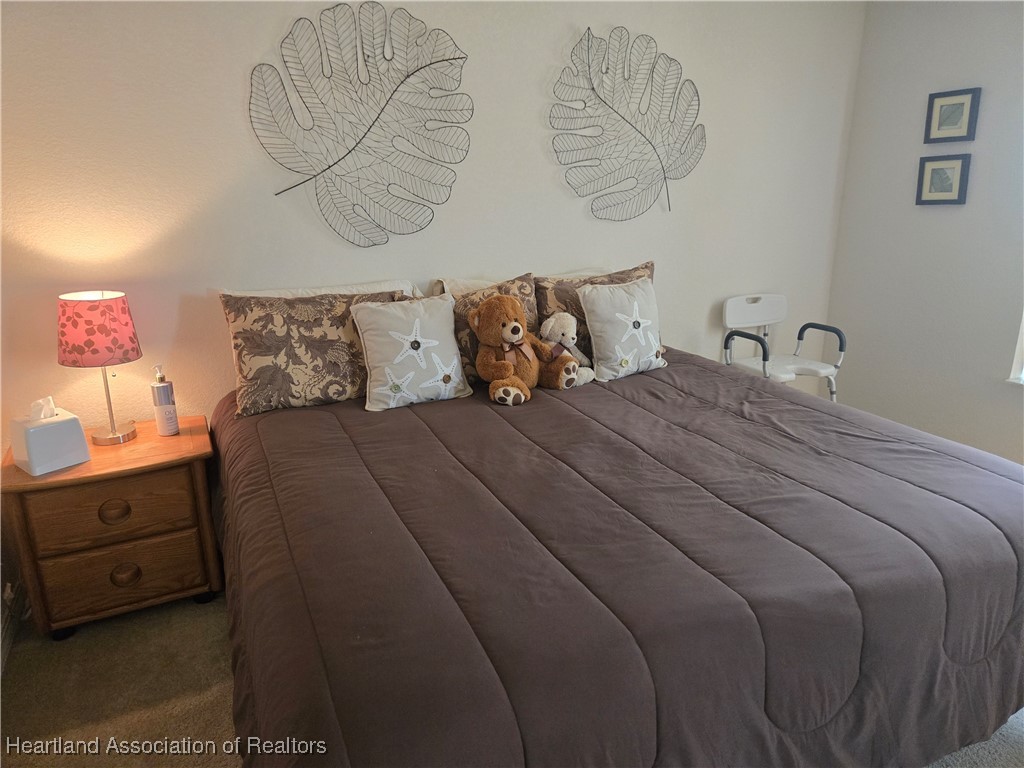 3312 Beartooth Pass Sebring, FL 33872 - Photo 19 of 39 a bedroom with a bed and painting on the wall