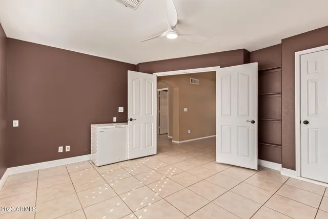 a spacious bedroom with a bed and window