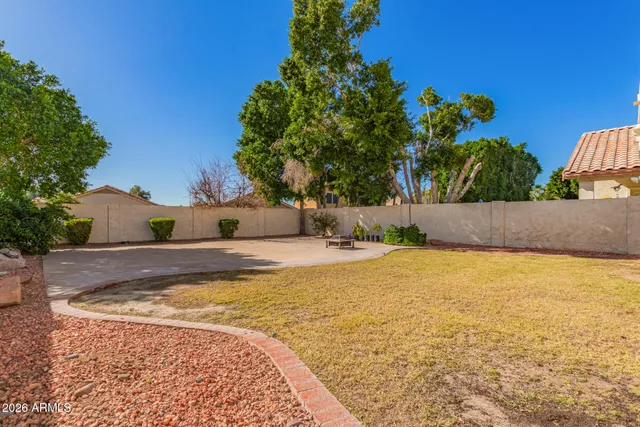 a view of a house with backyard and a tree