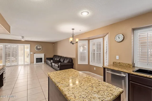 a large kitchen with a table and chairs in it