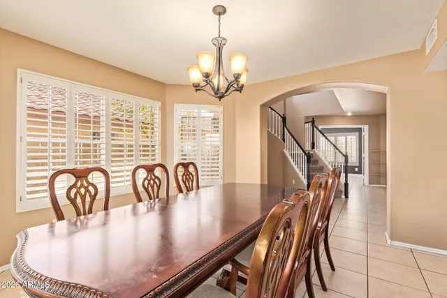 a view of a dining room with furniture wooden floor and chandelier