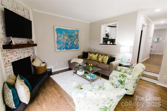 a living room with furniture fireplace and flat screen tv