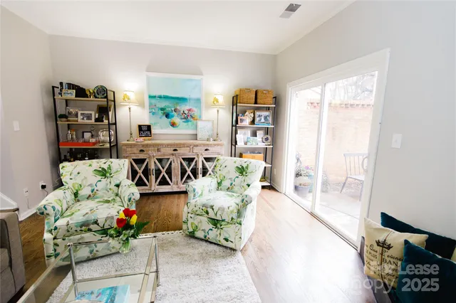a living room with furniture and flowers
