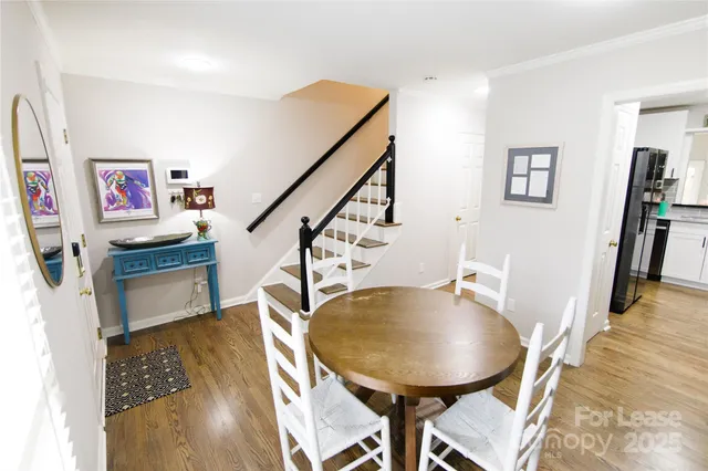 a view of a room with furniture and wooden floor