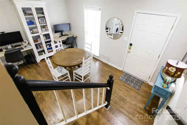 a view of a hallway with furniture and floor to ceiling window