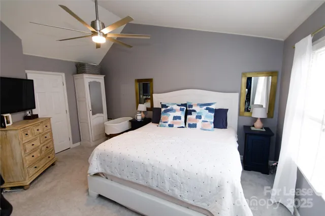 a bed room with furniture and a flat screen tv