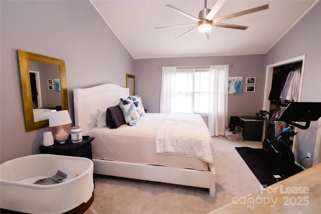 a bedroom with a bed and a potted plant