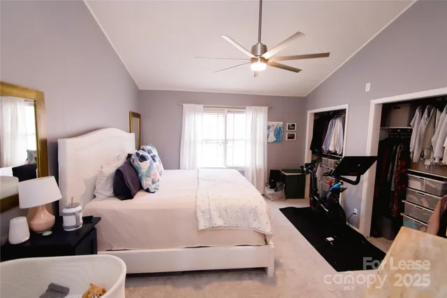 a bedroom with a bed and a flat tv screen on dresser