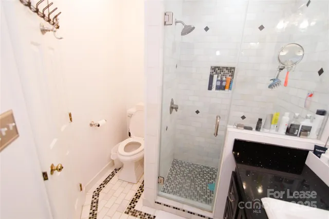 a bathroom with a sink toilet and shower