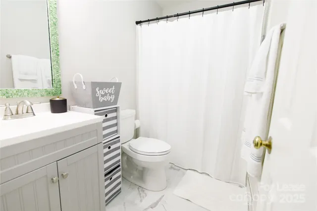 a white toilet sitting next to a bathroom sink