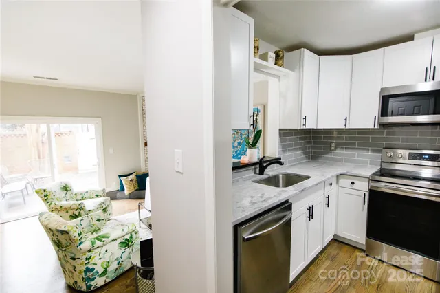 a kitchen with a sink stove and cabinets