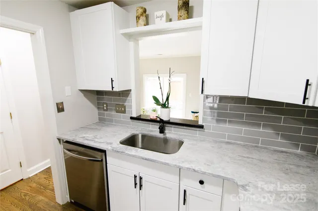 a kitchen with sink cabinets and stove